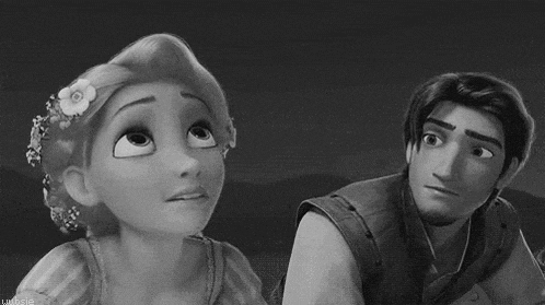 a black and white photo of a man and a woman looking at each other .