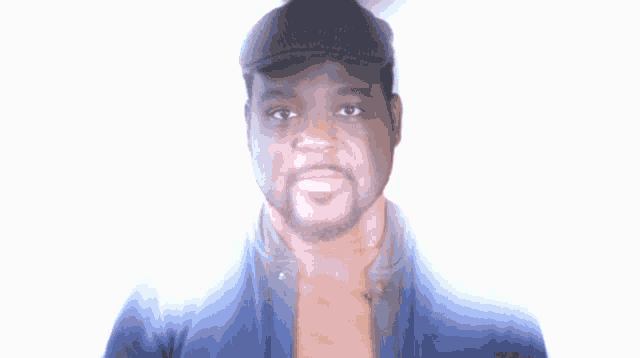 a man wearing a black hat and a blue shirt is smiling