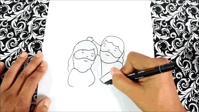 a person is drawing a couple with a marker that says ' prismacolor ' on it