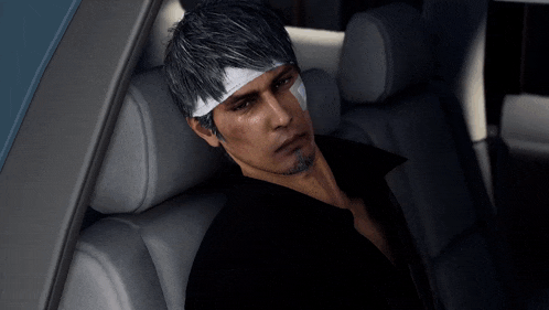 a man with a bandage on his forehead sits in the back seat of a car
