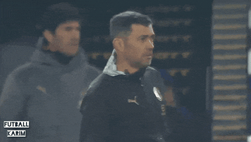 a blurred image of a soccer player with the words futball karim on the bottom