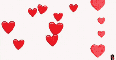 a bunch of red hearts are floating in the air .