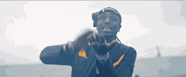 a man wearing glasses and a headband is clapping