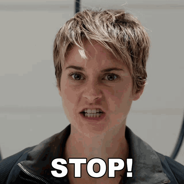 a woman with short hair is making a funny face and the word stop is above her face
