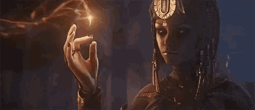 a woman in a crown is holding a torch in her hand .