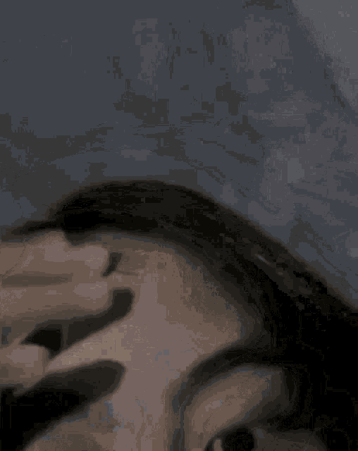 a close up of a woman 's forehead with her eyes closed and a hat on .