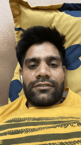 a man with a beard wearing a yellow shirt that says angry