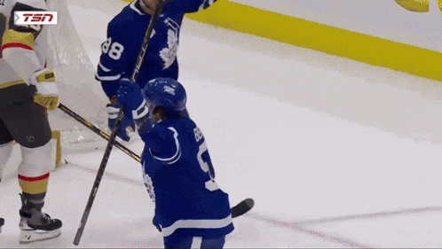 a hockey player with the number 28 on his jersey stands on the ice