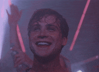 a man is laughing with his mouth open in a crowd
