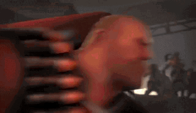 a blurry picture of a person holding a red heart in their hands .
