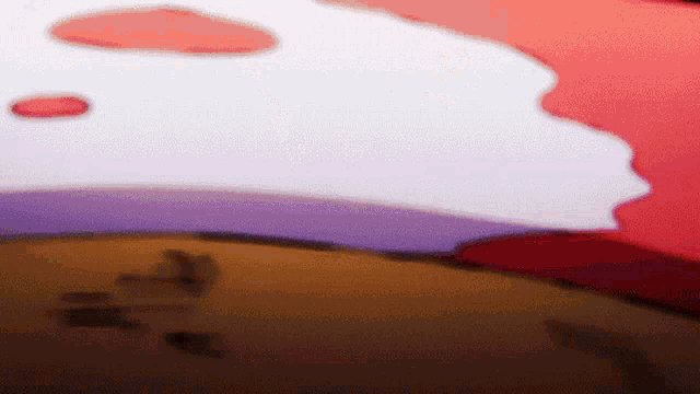 a blurred image of a red , white and purple background with a purple circle in the middle .