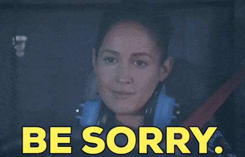 a woman sitting in a car with the words be sorry on the screen