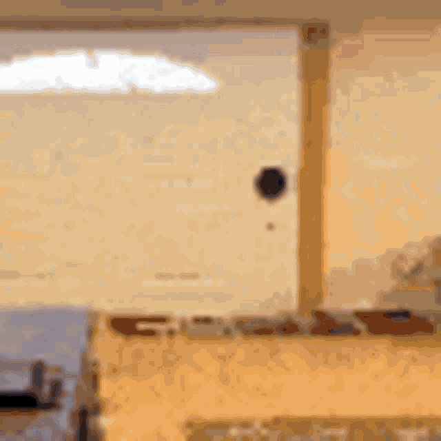 a blurred image of a living room with a view of the ocean through a window .