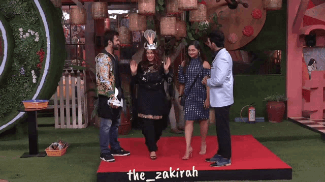 a group of people standing on a red carpet with the hashtag the_zakirah on it
