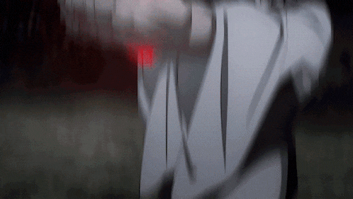 a blurry picture of a person 's face with a red light behind them
