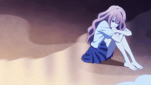 a girl in a blue skirt is sitting on the ground