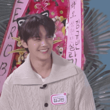 a young man wearing a name tag that says kim