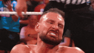 a man with a beard is making a funny face in a ring .