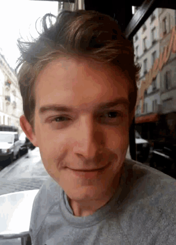 a close up of a man 's face with a sign in the background that says ' l' amour '