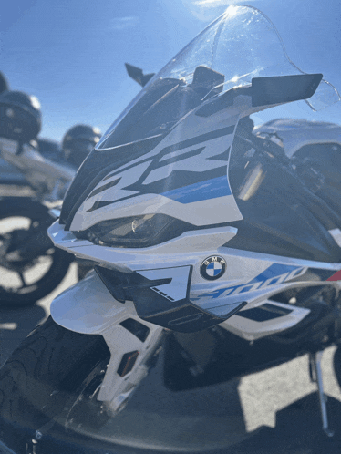 a bmw motorcycle is parked in a parking lot with other motorcycles