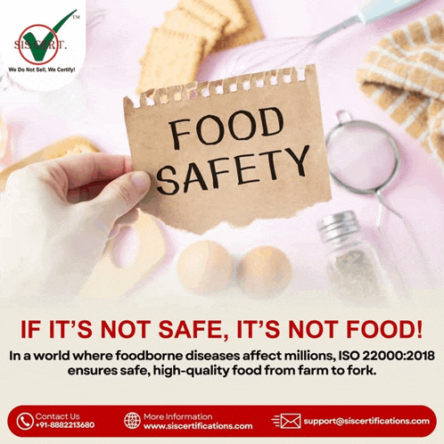 a hand holds a piece of paper that says food safety