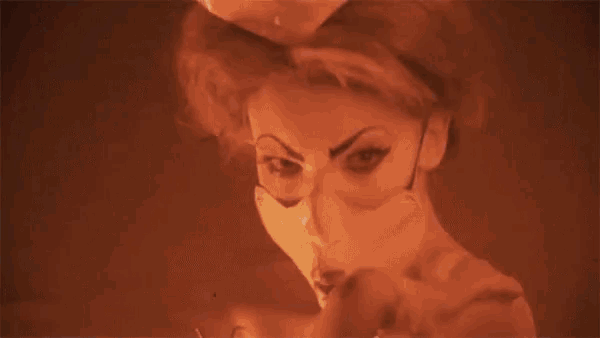 a woman with glowing eyes and a mask on her face