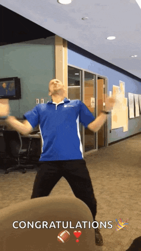 a man in a blue shirt is jumping in the air with the words congratulations behind him