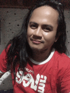 a man with long hair is wearing a red shirt that says ' soul '