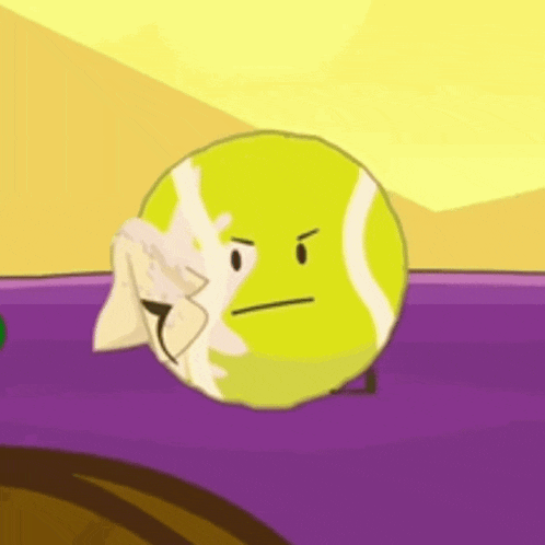 a tennis ball with a towel on it 's face is sitting on a purple surface .