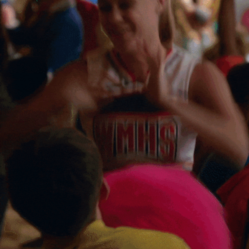 a cheerleader wearing a uniform that says mhs on the front