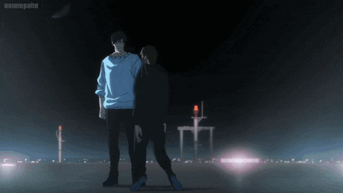 a man in a white sweater is standing next to a woman in a dark room with a red light in the background