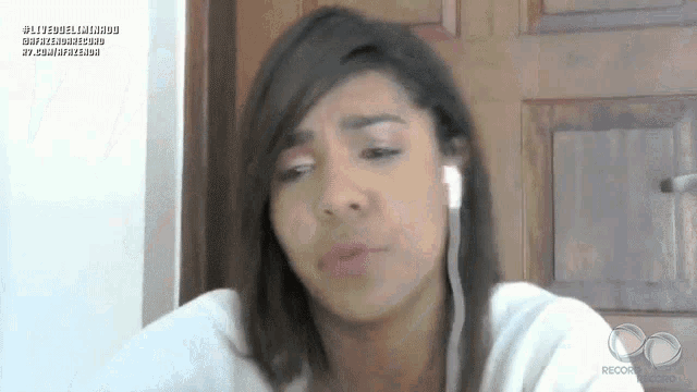 a woman wearing ear buds looks at the camera with a watermark that says ' record ' on it