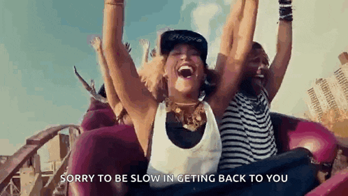 a woman is riding a roller coaster with her hands in the air .