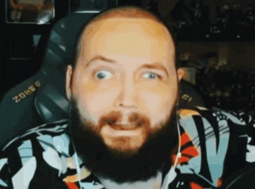 a man with a beard is wearing a shirt that says zone