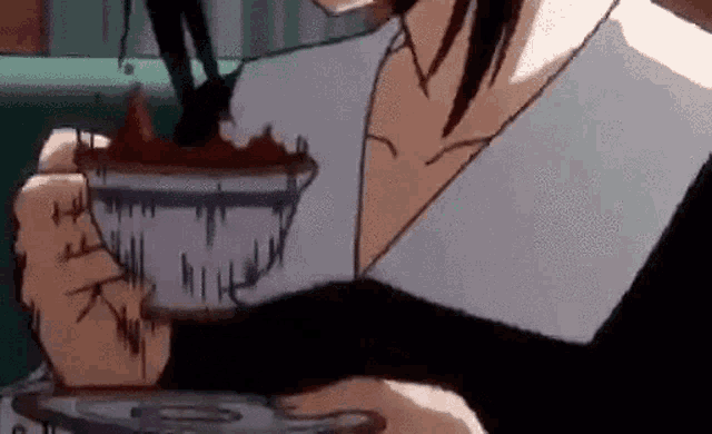 a person is holding a cup of coffee with a saucer .