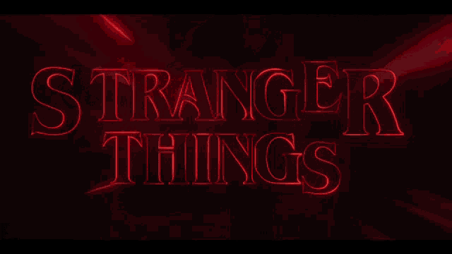 a red stranger things 4 logo is lit up in the dark