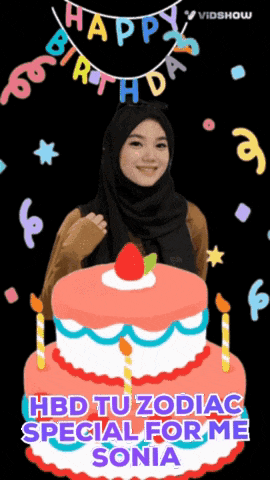 a woman in a hijab is standing in front of a birthday cake