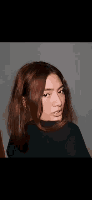 a close up of a woman 's face with a blurred background .