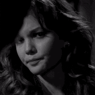 a close up of a woman 's face in black and white