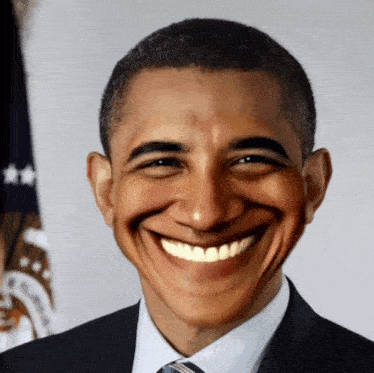 a man in a suit and tie is smiling in front of the flag of the united states of america