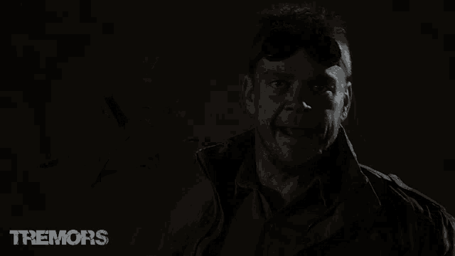 a man wearing goggles and a jacket with tremors written on it