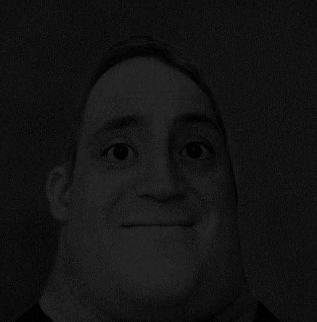 a black and white photo of a man making a face