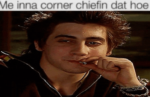 a man smoking a cigarette with a caption that says me inna corner chifin dat hoe