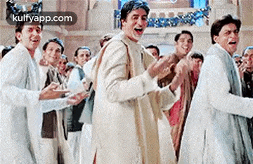 a group of men are dancing in a room and laughing .
