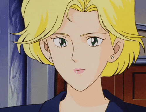 a woman with blonde hair and green eyes looks at the camera