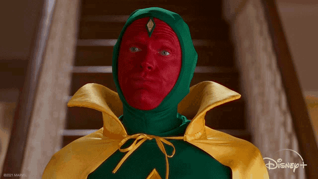 a man in a green and yellow cape with red paint on his face says yes