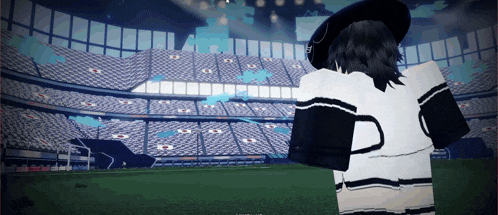 a person is standing in front of a stadium with a sign that says ' a ' on it