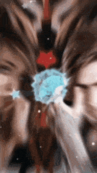 a blurry picture of a woman holding a blue flower in her hair .