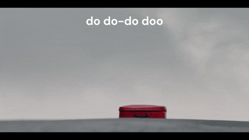 a red suitcase with a bird on top of it and the words do do-do doo
