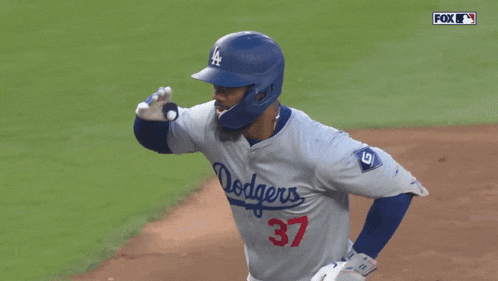 a baseball player wearing a dodgers jersey and helmet